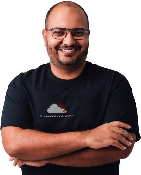 Jean Rodrigues, Founder, CEO & CTO of The Cloud Bootcamp, smiling with his arms crossed.